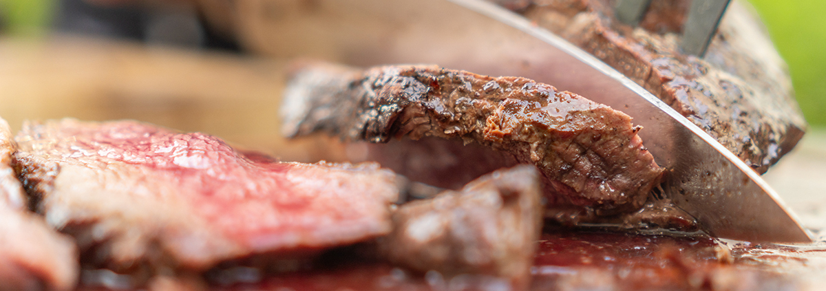 Man cutting venison for venison recipes