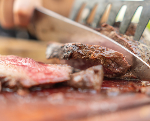 Man cutting venison for venison recipes