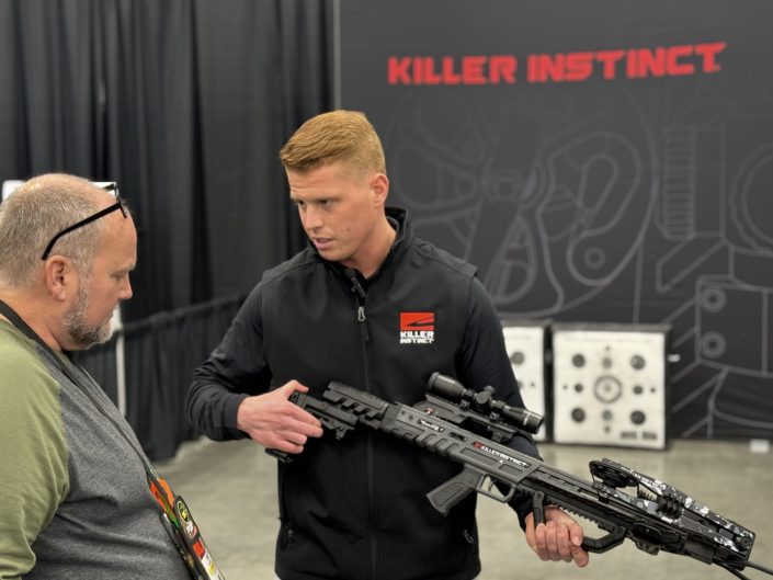 Man demonstrating a Killer Instinct crossbow at the ATA Show